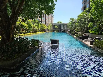 a swimming pool with blue tiles on the ground at Valley Mountain ViewCity Proximity Golden Eight Apartment in Phuket Town