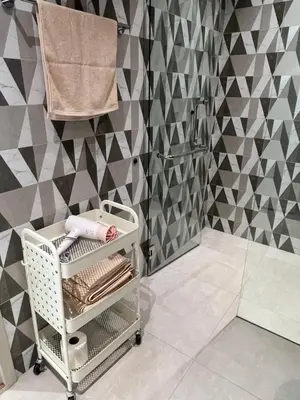 a bathroom with a towel rack and a shower at Sun Sea Sand in Thalang