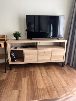 a entertainment center with a flat screen tv on it at Sun Sea Sand in Thalang