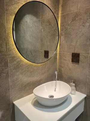 a bathroom with a white sink and a mirror at Sun Sea Sand in Thalang