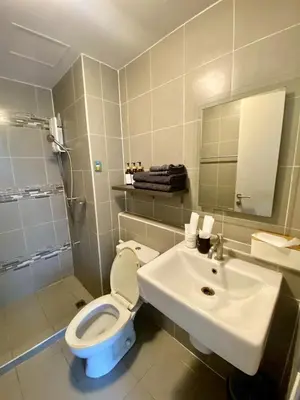 a bathroom with a toilet and a sink at Nassaree Condo in Phuket Town