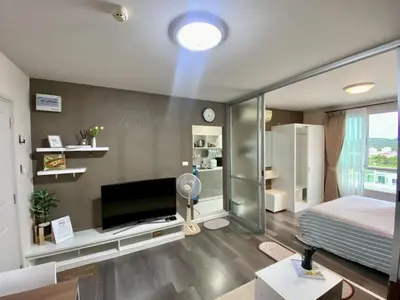 a bedroom with a bed and a tv in a room at Nassaree Condo in Phuket Town