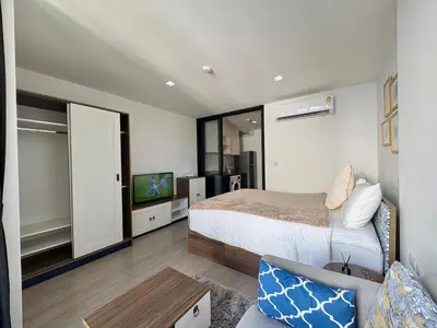 a bedroom with a bed and a tv and a couch at 1 Bedroom close to Central Shopping Mall in Ban Rangeng