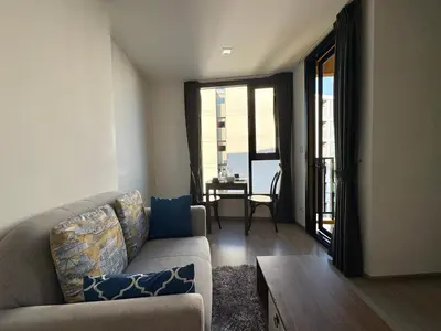 a living room with a couch and a table at 1 Bedroom close to Central Shopping Mall in Ban Rangeng