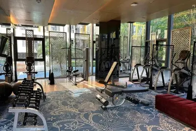a gym with several treadmills and exercise machines at 1 Bedroom close to Central Shopping Mall in Ban Rangeng