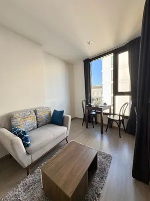 a living room with a couch and a table at 1 Bedroom close to Central Shopping Mall in Ban Rangeng