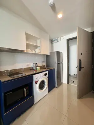 a kitchen with a washing machine and a washer at 1 Bedroom close to Central Shopping Mall in Ban Rangeng