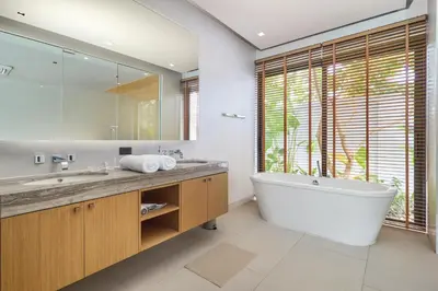 a bathroom with a large tub and a large mirror at Botanica Four Seasons Bang Tao by My Home Phuket in Ban Na Sok