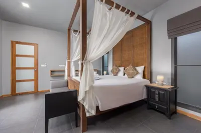 a bedroom with a large bed with a canopy at Villa Kiana 2BR Private Pool 10 min to Nai Harn in Ban Saiyuan (1)