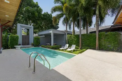 a swimming pool with two chairs and a house at Villa Kiana 2BR Private Pool 10 min to Nai Harn in Ban Saiyuan (1)