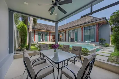 a patio with a table and chairs and a pool at Villa Kiana 2BR Private Pool 10 min to Nai Harn in Ban Saiyuan (1)