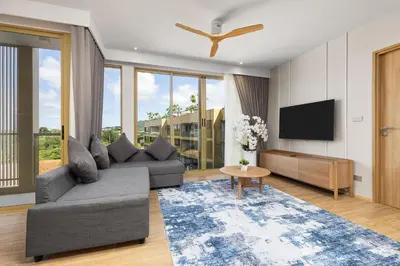a living room with a couch and a tv at Laguna BeachSide Bang Tao by My Home Phuket in Bang Tao Beach