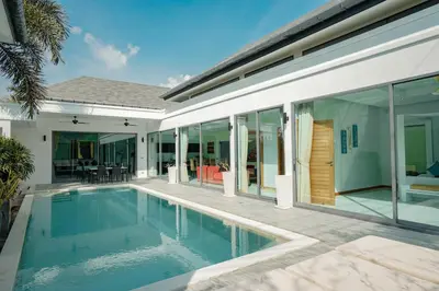 a swimming pool in front of a house at Villa Heaven - Peaceful 3 Bedroom Private Pool Villa in Ban Kata