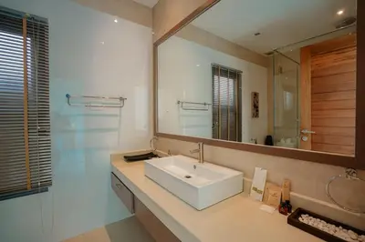 a bathroom with a sink and a large mirror at Villa Heaven - Peaceful 3 Bedroom Private Pool Villa in Ban Kata