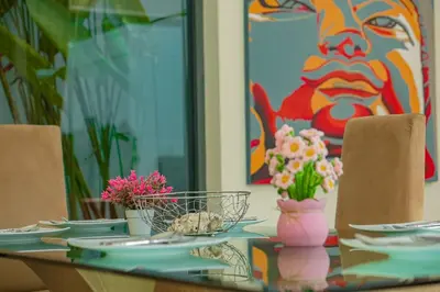 a table with plates and flowers on top of it at Villa Heaven - Peaceful 3 Bedroom Private Pool Villa in Ban Kata