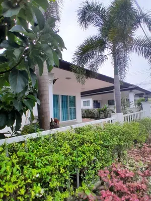 a house with a palm tree in front of it at Baan Saun PK in Ban Bang La