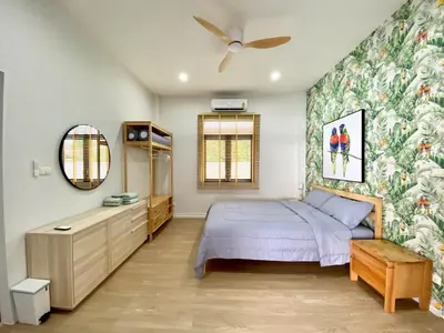 a bedroom with a bed and a flowery wallpaper at Baanthai villa Rawai in Rawai Beach