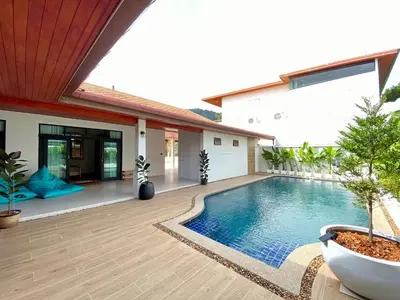 a swimming pool in the backyard of a house at Baanthai villa Rawai in Rawai Beach