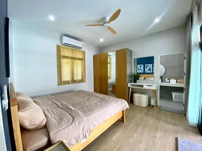 a bedroom with a bed and a ceiling fan at Baanthai villa Rawai in Rawai Beach