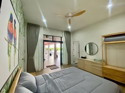 a bedroom with a bed and a ceiling fan at Baanthai villa Rawai in Rawai Beach