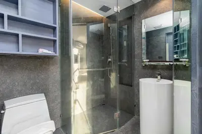 a bathroom with a toilet and a glass shower at C255 Best Stay Experience Condo with Full Facilities in Kamala Beach