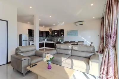 a living room with a couch and a kitchen at V274 Prime Location Large Terrace Pool View BBQ in Ban Saiyuan (1)