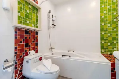 a bathroom with a toilet and a bath tub at V274 Prime Location Large Terrace Pool View BBQ in Ban Saiyuan (1)