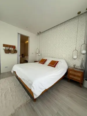 a bedroom with a large white bed and a wall at Pride luxury house in Koh Lone