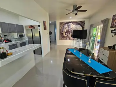 a kitchen with a table and chairs in a room at 2 Bedrooms Tropical Pool Villa Rawai in Rawai Beach