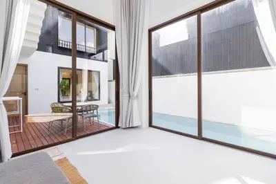 a room with a large window with a view of a patio at V275 Stay with Nature 2BR Peaceful Pool Villa in Ban Pak Lak