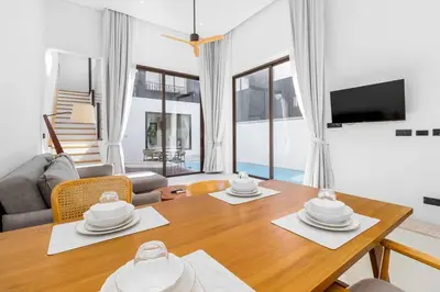 a living room with a wooden table and a dining room at V275 Stay with Nature 2BR Peaceful Pool Villa in Ban Pak Lak