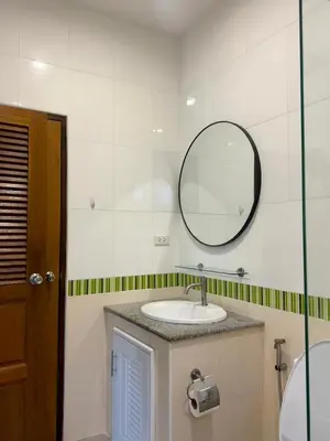 a bathroom with a sink and a mirror at Sea sand Bungalow in Phuket Town