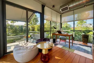 an open living room with a desk and large windows at RIVERHOUSE Solar-Powered Luxury Pool Villas in Laguna Phuket