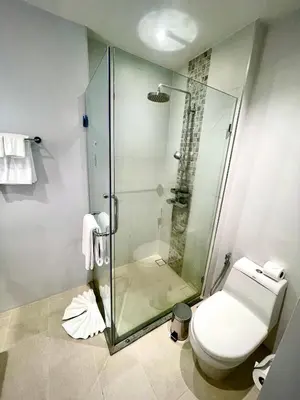 a bathroom with a glass shower and a toilet at Diamond Resort 1 Bdr Bang Tao in Bang Tao Beach