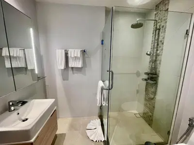 a bathroom with a shower and a sink at Diamond Resort 1 Bdr Bang Tao in Bang Tao Beach