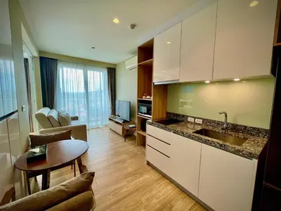 a kitchen with a sink and a table in a room at Diamond Resort 1 Bdr Bang Tao in Bang Tao Beach