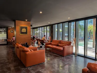 a lobby with leather couches and people in a building at Comfortable 1 bdr Kamala City Gate in Kamala Beach