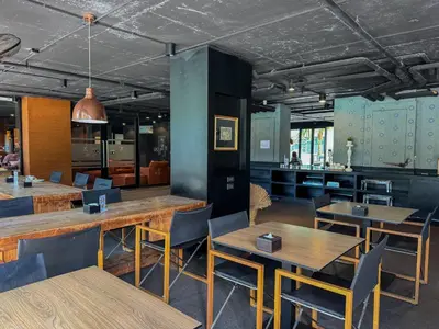 a dining room with wooden tables and chairs at Comfortable 1 bdr Kamala City Gate in Kamala Beach