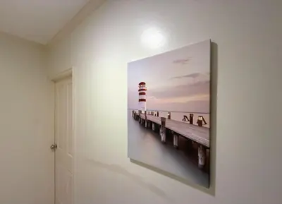 a painting of a lighthouse on a wall at Highest Apartment in Phuket Panaromic Seaview in Patong Beach