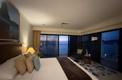 a bedroom with a large bed with a large window at Highest Apartment in Phuket Panaromic Seaview in Patong Beach