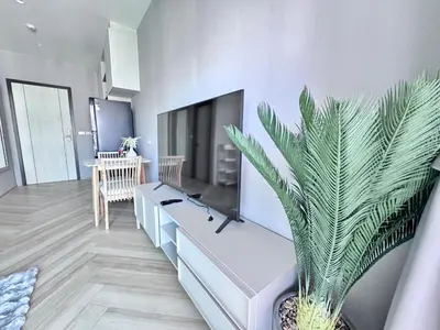 a living room with a flat screen tv and a plant at Title Legendary 7 floor Mountain View in Bang Tao Beach