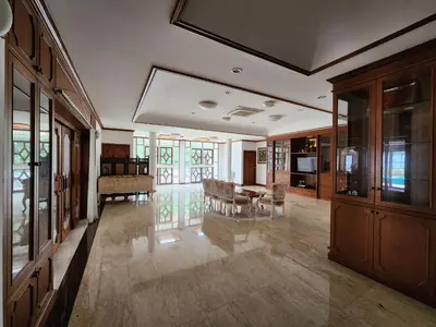 a large living room with a table and a couch at Villa Vasu in Ban Bang Khu