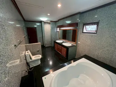 a bathroom with two sinks and a large tub at Villa Vasu in Ban Bang Khu