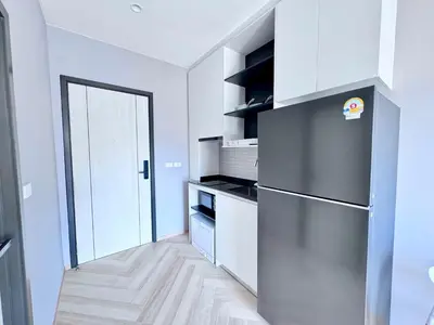 a kitchen with a stainless steel refrigerator and white cabinets at Title Ledgendary 7th Floor in Bang Tao Beach
