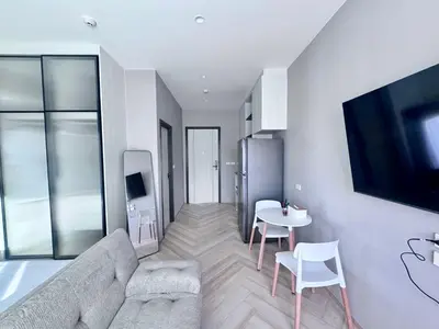 a living room with a couch and a table at Title Ledgendary 7th Floor in Bang Tao Beach