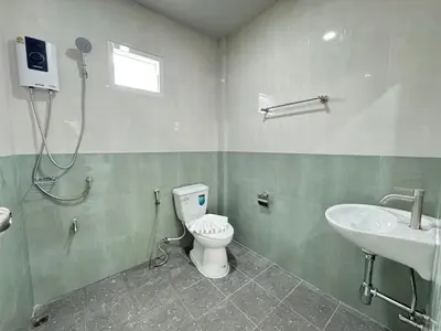 a bathroom with a toilet and a sink at Karon Little House in Karon Beach