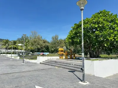 a street light in a park with stairs and trees at Karon Little House in Karon Beach