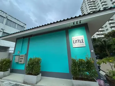a blue building with a sign on it at Karon Little House in Karon Beach