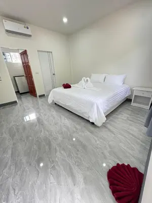 a bedroom with a large white bed in a room at Karon Little House in Karon Beach