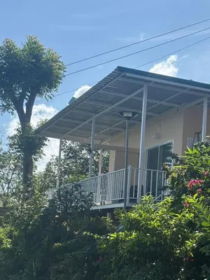 a house with a porch with awning on it at Mong Do Lay Baan Sea View in Ban Ao Makham